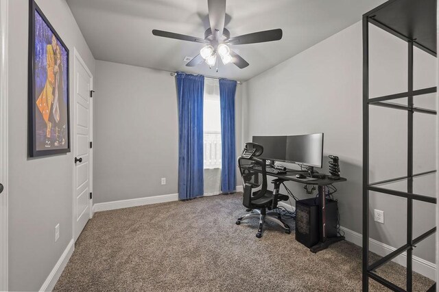 carpeted office featuring baseboards and a ceiling fan