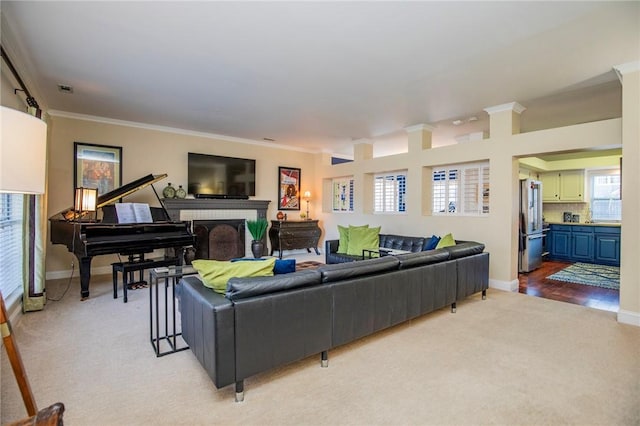 living room with baseboards, light carpet, and ornamental molding