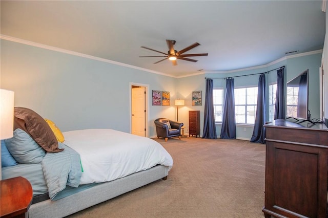 bedroom with ornamental molding, baseboards, ceiling fan, and carpet floors