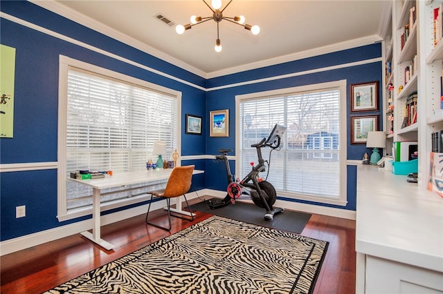 office space with visible vents, baseboards, hardwood / wood-style floors, ornamental molding, and a notable chandelier