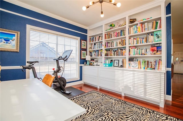 office with built in features, wood finished floors, a chandelier, and crown molding