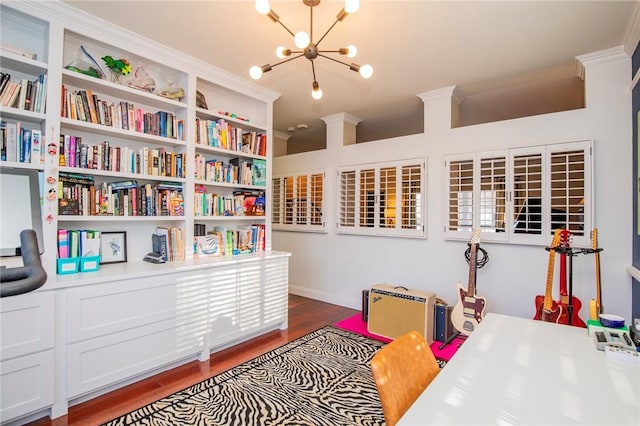 interior space with wood finished floors, a chandelier, and crown molding