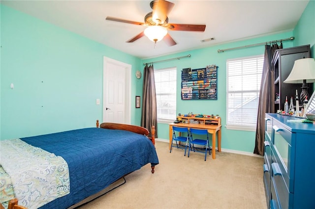 bedroom featuring visible vents, light colored carpet, a ceiling fan, and baseboards