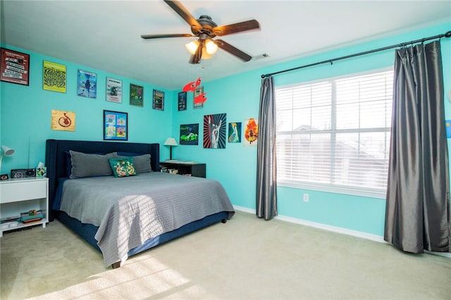 bedroom featuring ceiling fan, baseboards, and carpet