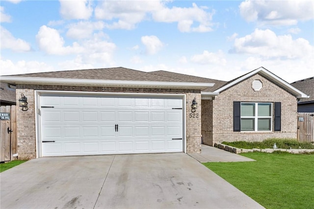 ranch-style home with an attached garage, fence, brick siding, and roof with shingles