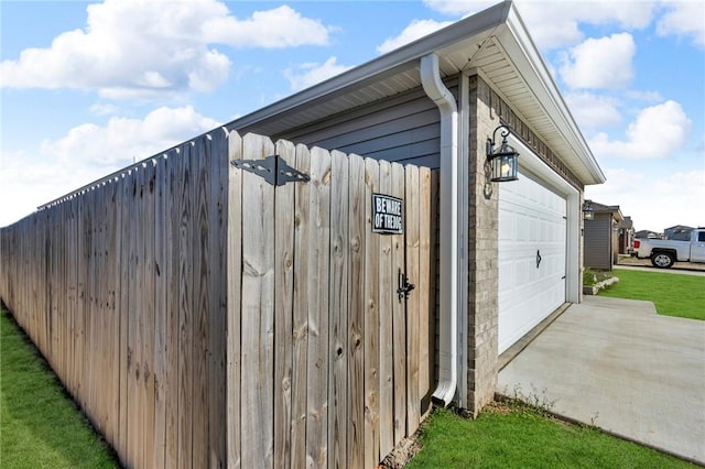 view of home's exterior with a gate, a lawn, and fence