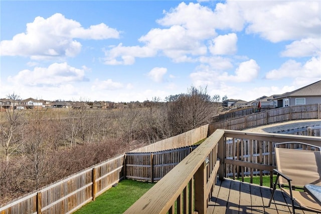 wooden deck featuring a residential view and a fenced backyard