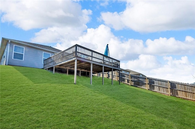 view of yard with a deck and fence