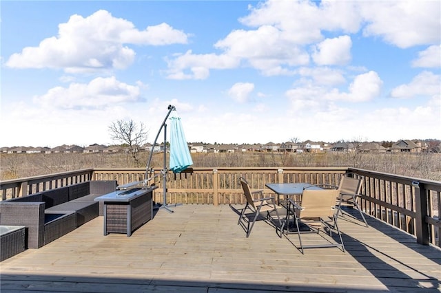 wooden terrace with outdoor dining space and outdoor lounge area