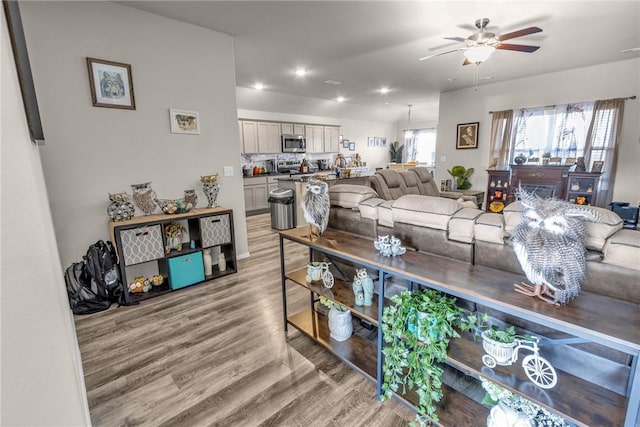 living room featuring recessed lighting, light wood-type flooring, and ceiling fan