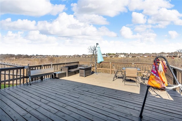 wooden terrace with outdoor dining space