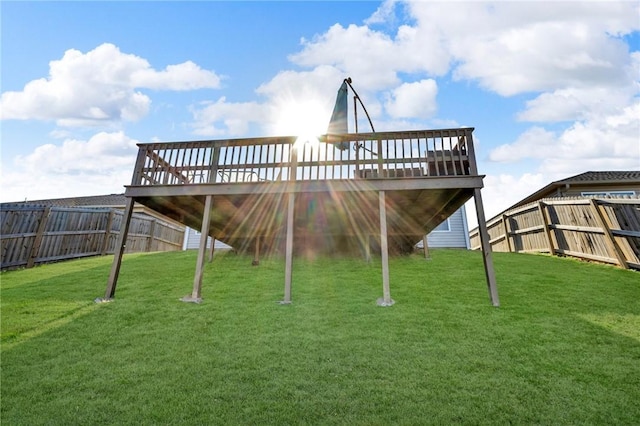 exterior space featuring a deck, a lawn, and a fenced backyard