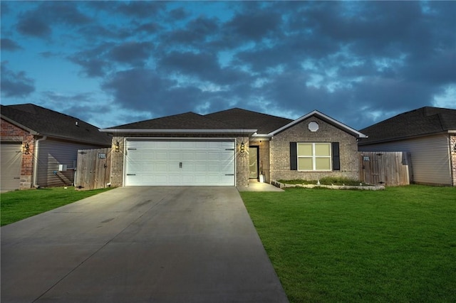 single story home featuring brick siding, fence, a front yard, a garage, and driveway