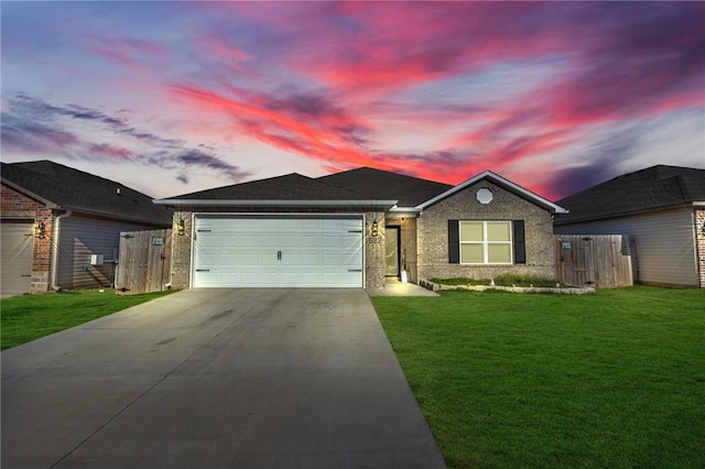 single story home featuring brick siding, fence, concrete driveway, a yard, and a garage