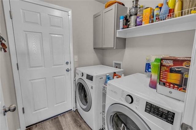 laundry room with cabinet space, dark wood-style floors, and washer and clothes dryer