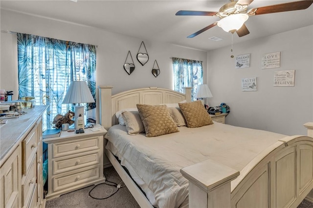 bedroom with visible vents, a ceiling fan, and carpet floors