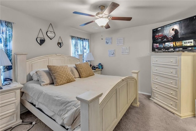 bedroom with light colored carpet, baseboards, and ceiling fan