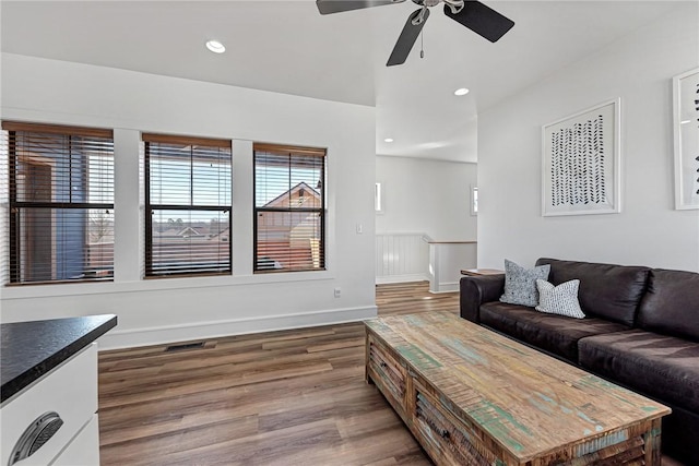 living area featuring a ceiling fan, recessed lighting, wood finished floors, and baseboards