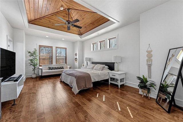 bedroom with a raised ceiling, wooden ceiling, and hardwood / wood-style flooring