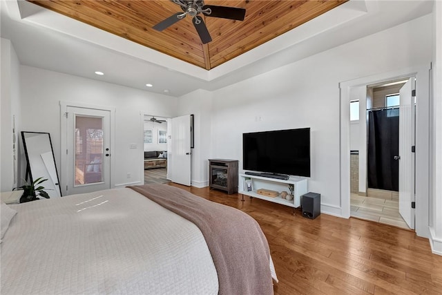 bedroom with hardwood / wood-style floors, baseboards, a tray ceiling, recessed lighting, and wood ceiling