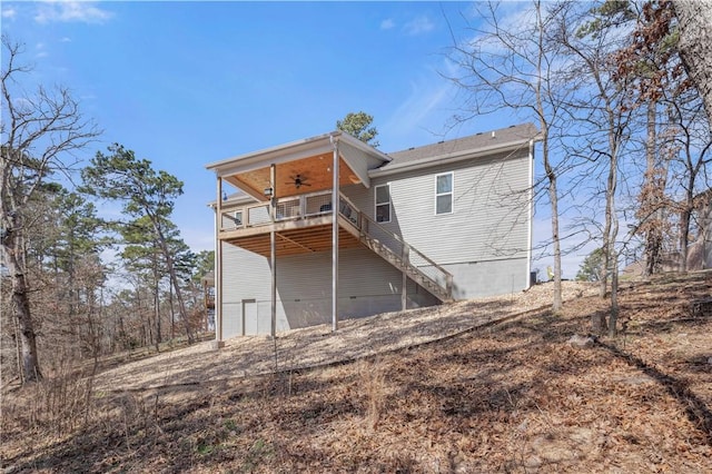 back of house featuring crawl space, ceiling fan, and stairs