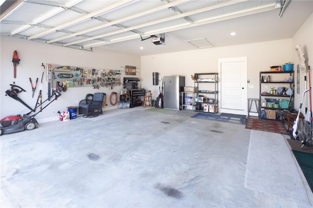 garage featuring a garage door opener and freestanding refrigerator