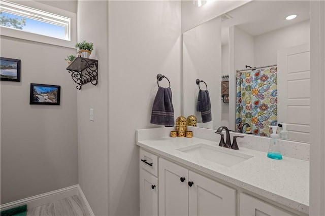 bathroom featuring vanity, a shower with shower curtain, recessed lighting, and baseboards