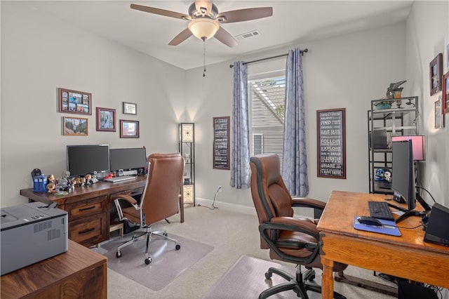 home office with baseboards, visible vents, carpet floors, and ceiling fan