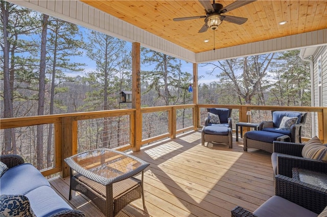 wooden deck with a ceiling fan and outdoor lounge area