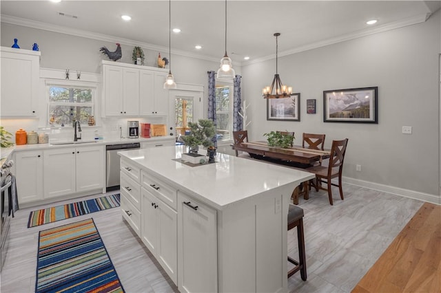 kitchen featuring a sink, stainless steel dishwasher, ornamental molding, and light countertops