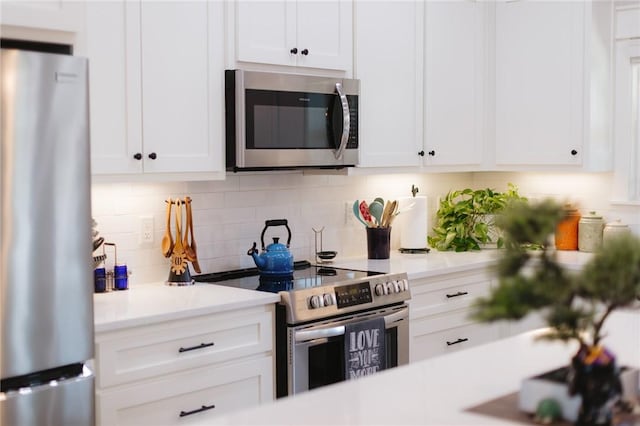 kitchen featuring white cabinetry, stainless steel appliances, and light countertops