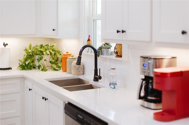 kitchen featuring a sink, dishwasher, white cabinets, and light countertops