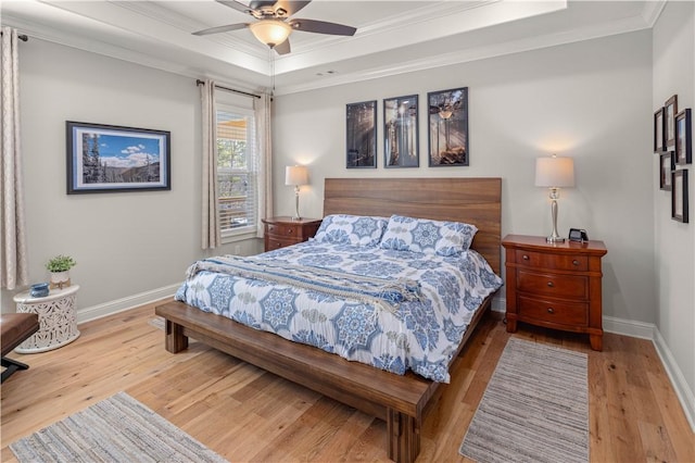 bedroom with baseboards, wood finished floors, and ornamental molding