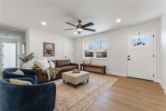 living area with light wood-style flooring, recessed lighting, baseboards, and ceiling fan