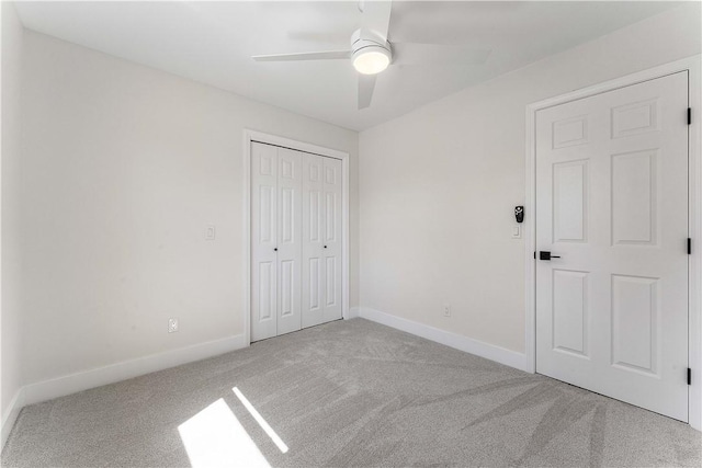 unfurnished bedroom with a closet, ceiling fan, baseboards, and carpet floors