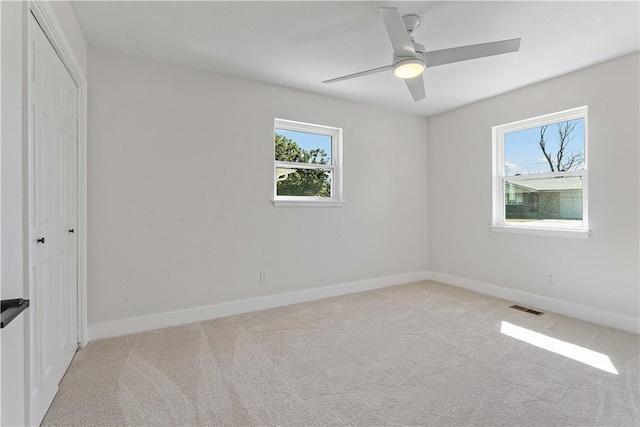 unfurnished bedroom featuring visible vents, a closet, carpet, baseboards, and ceiling fan