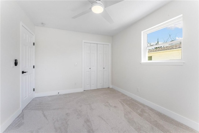 unfurnished bedroom featuring a closet, baseboards, carpet, and ceiling fan