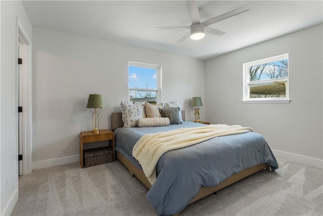 bedroom featuring multiple windows, baseboards, and carpet floors