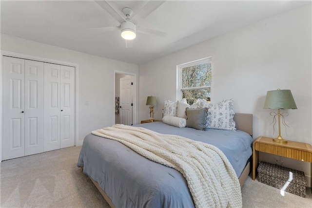 bedroom featuring ceiling fan, a closet, and light carpet