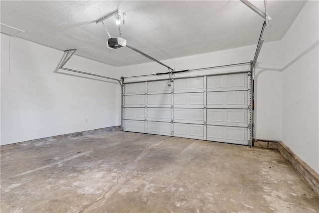 garage with baseboards and a garage door opener