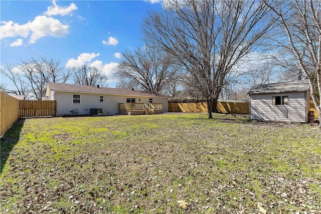 view of yard featuring a fenced backyard, a storage unit, central AC, and an outdoor structure