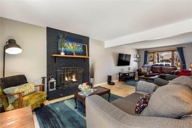 tiled living room featuring baseboards and a fireplace