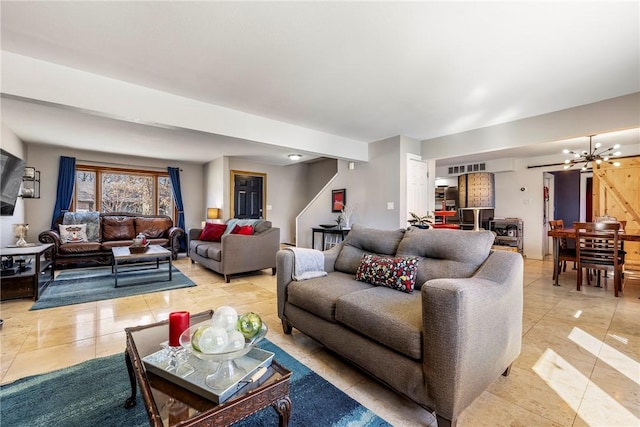 living area featuring light tile patterned floors and a notable chandelier