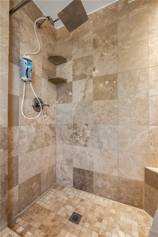 bathroom with a tile shower