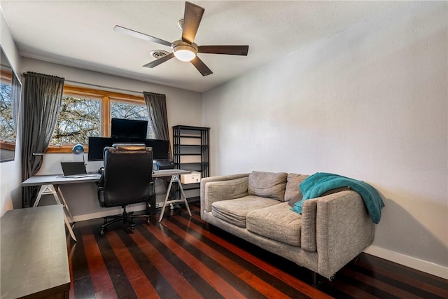 home office featuring wood finished floors, a ceiling fan, and baseboards