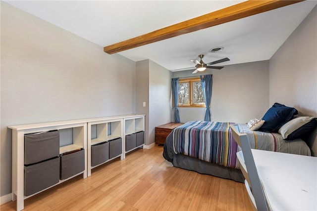 bedroom with visible vents, beam ceiling, a ceiling fan, light wood-style floors, and baseboards