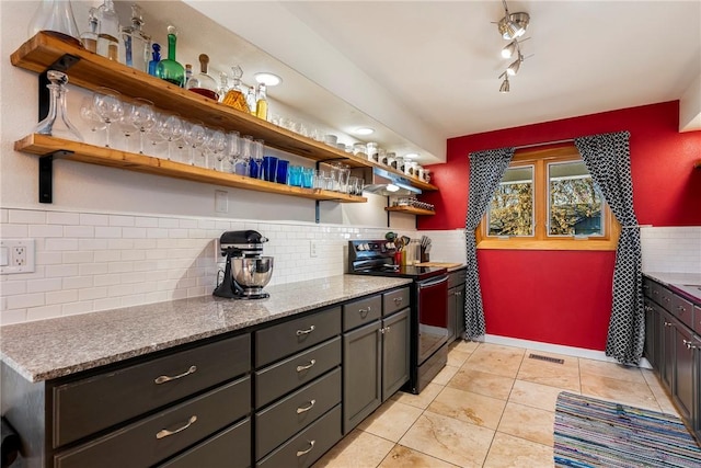 kitchen featuring light tile patterned floors, light stone countertops, visible vents, open shelves, and black range with electric cooktop