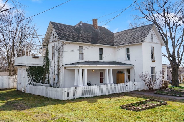 view of front of home with fence, roof with shingles, a front yard, stucco siding, and a chimney