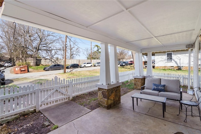 view of patio / terrace featuring an outdoor living space and a fenced front yard