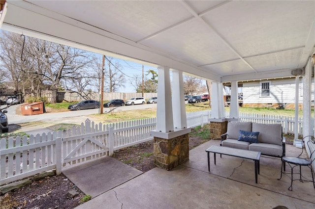 view of patio / terrace featuring outdoor lounge area and fence